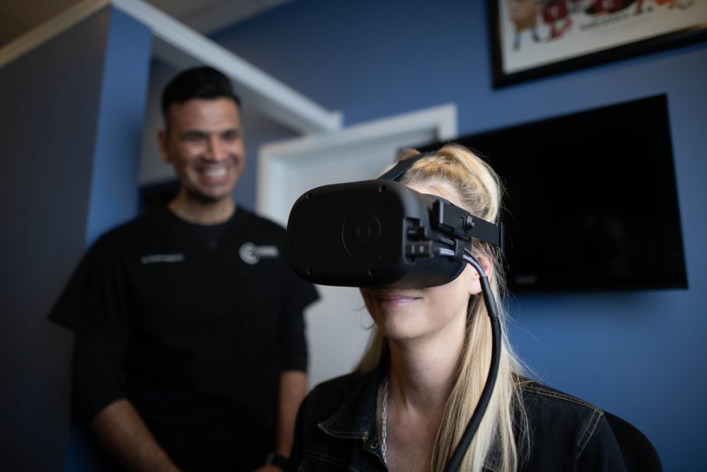 Dr. Posada guiding a patient through VR-based vestibular and brain-rehab testing at CoreNeuro