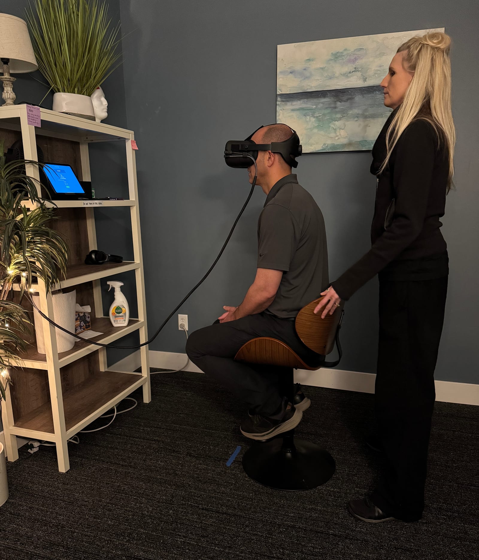 A CoreNeuro clinician guiding a patient through VR-based neurological and balance testing in Portage, MI